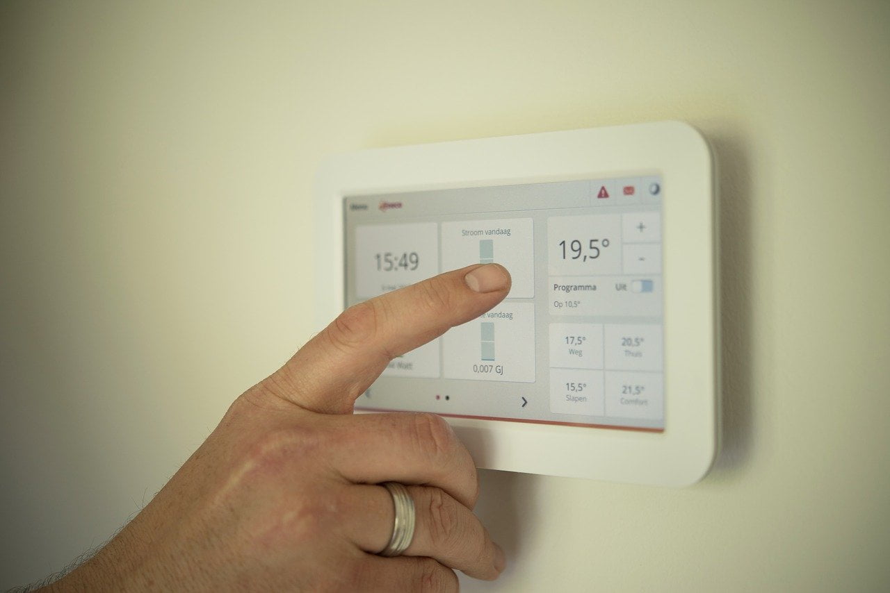 A touchscreen thermostat controls room temperature.