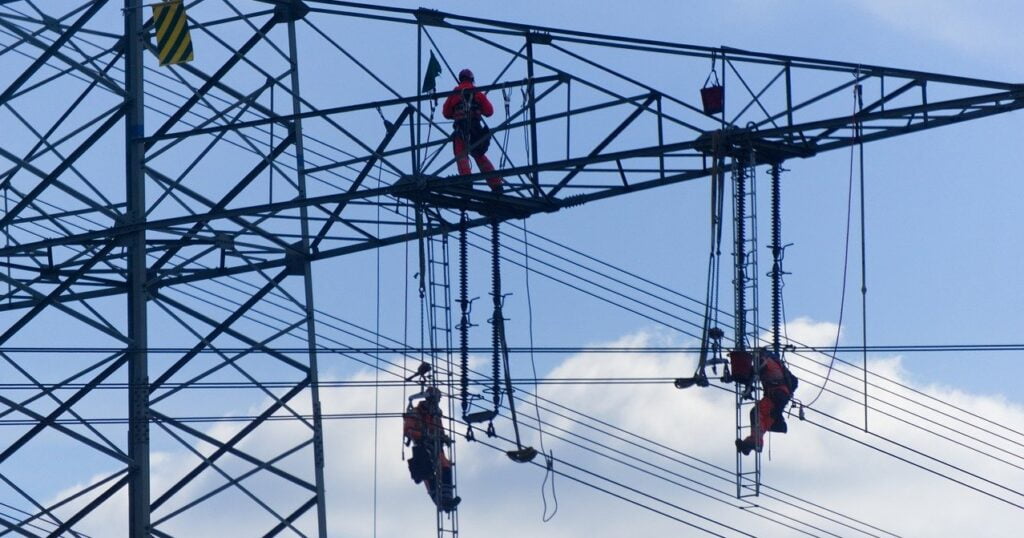 workers carrying out maintenance on an electricity pylon