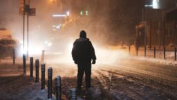 man in the snow at night europe