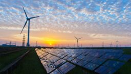 What will australia's national energy market look like after coal solar panels and windmills with a sunset in the background